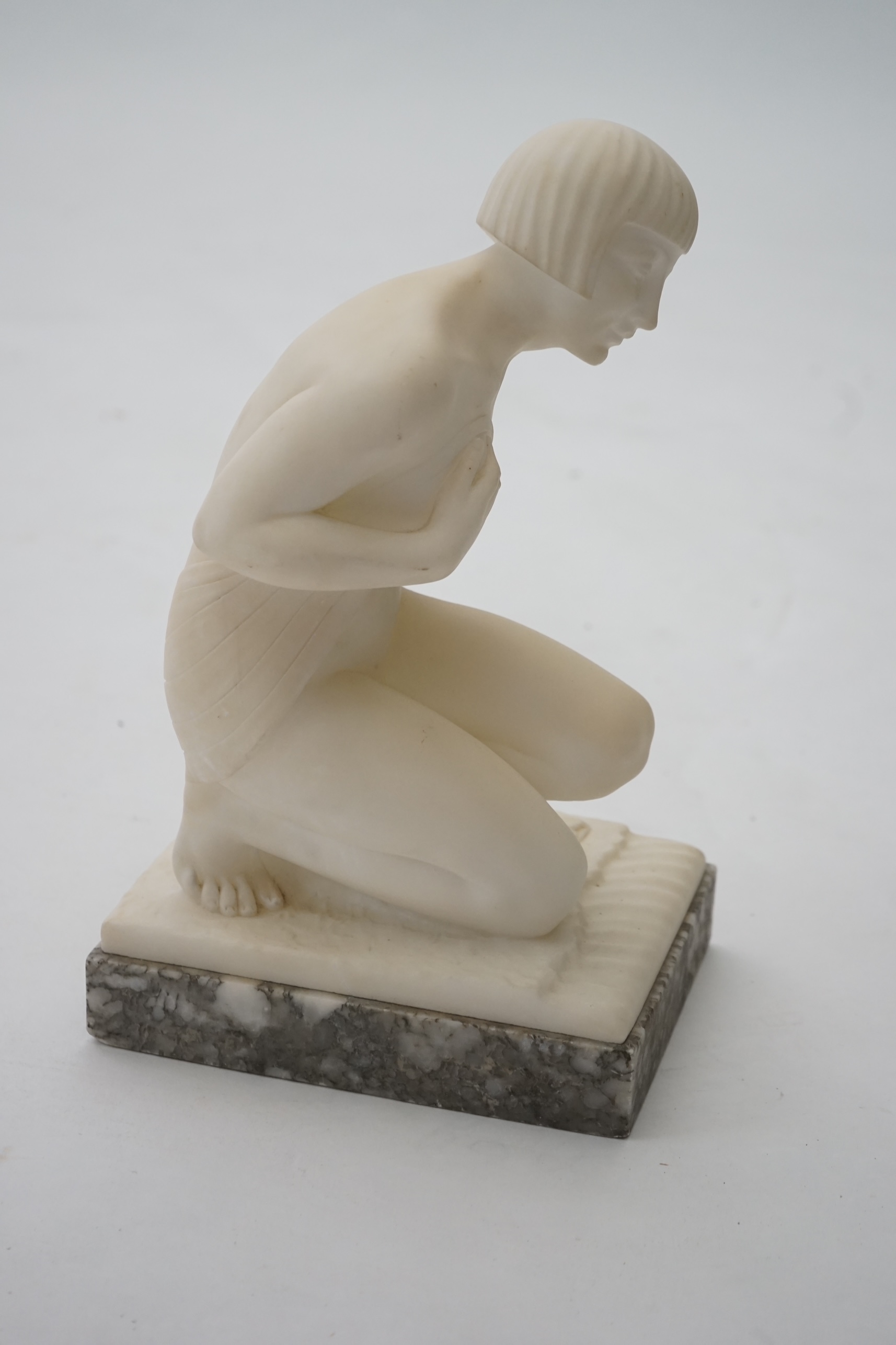 Manner of Gugliemo Pugi (1850-1915). An Italian Art Deco carved marble figure of a crouching bather kneeling and semi-draped